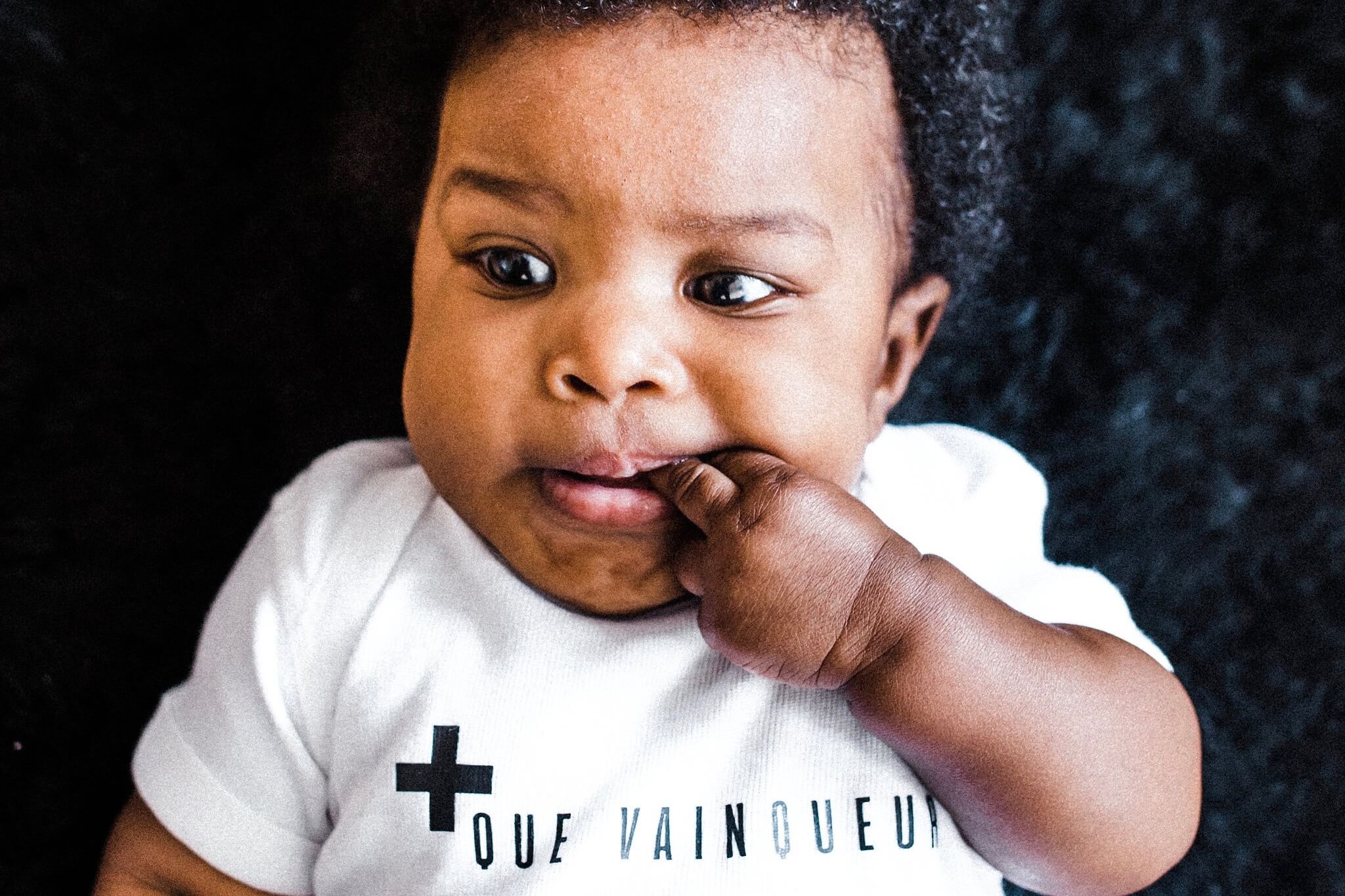 + Que Vainqueur Baby Bodysuit