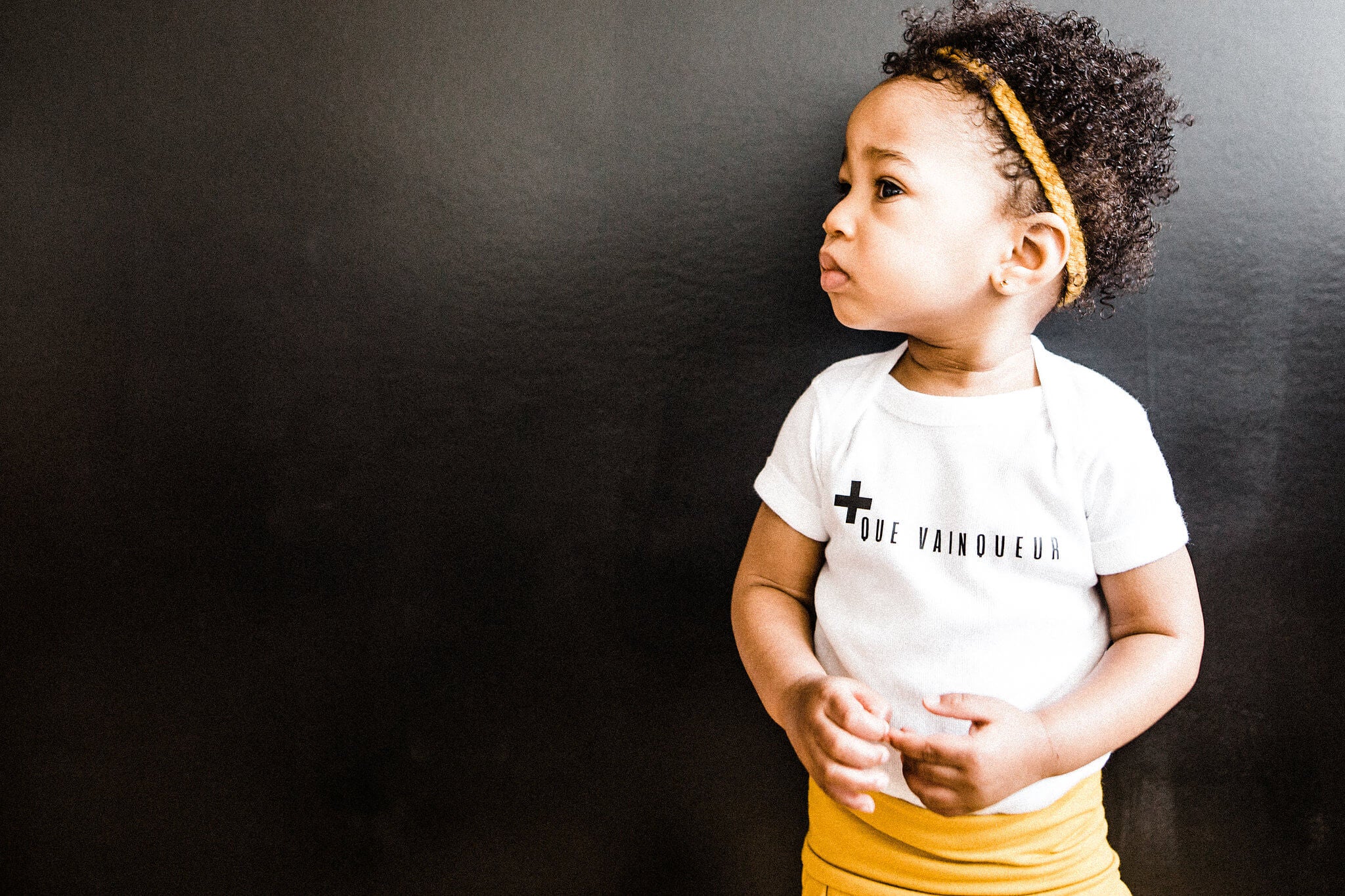 + Que Vainqueur Baby Bodysuit