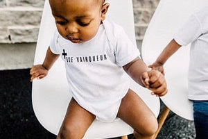 + Que Vainqueur Baby Bodysuit